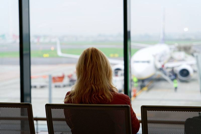 Woman sitting and waiting to board airplane