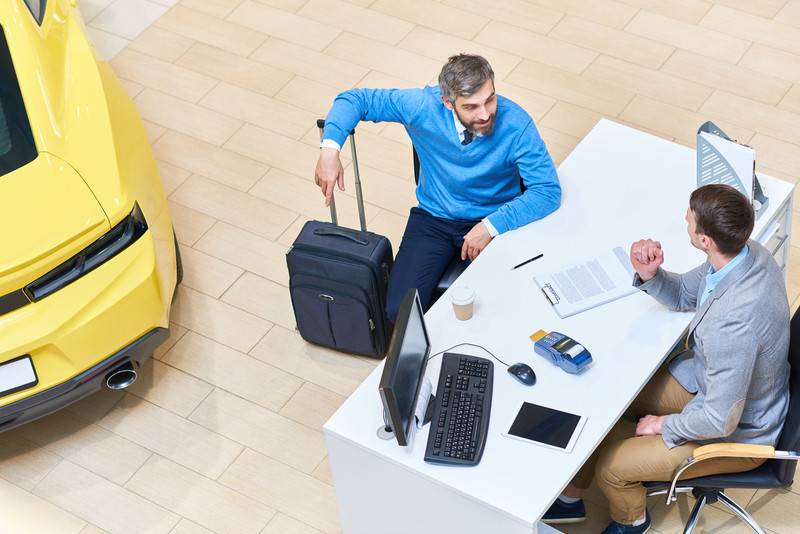 a man renting a car and going over agreement