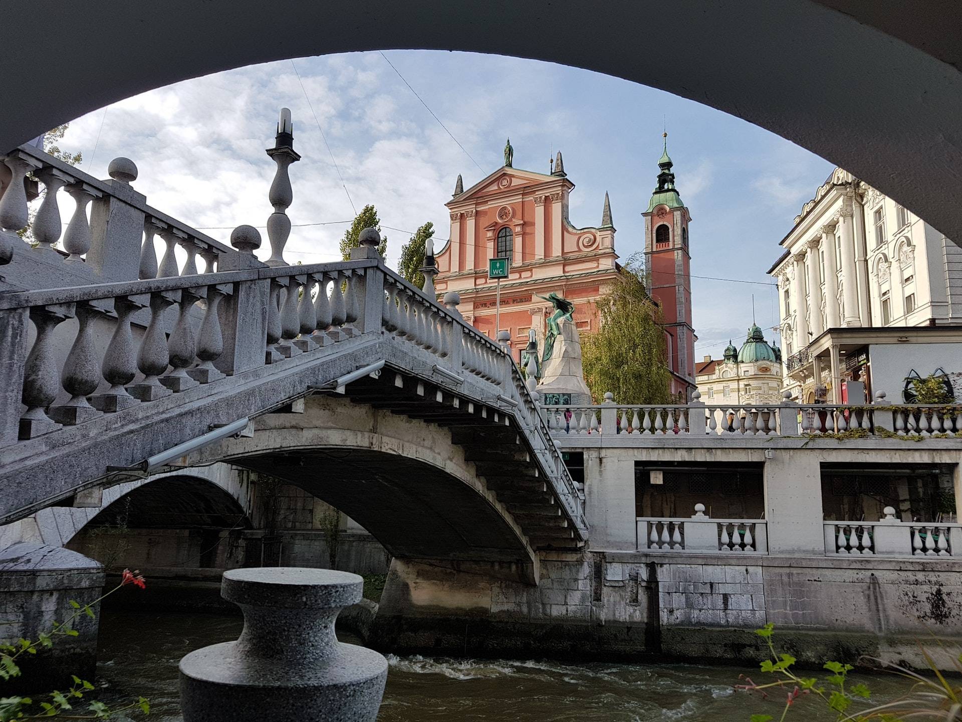 Pink church in Ljubljana with one of three bridges